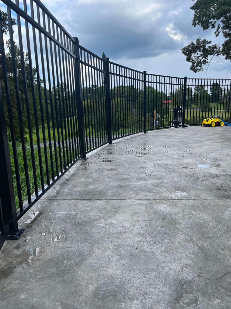 Curb Aluminum fence Installation by TM exterior Solutions
